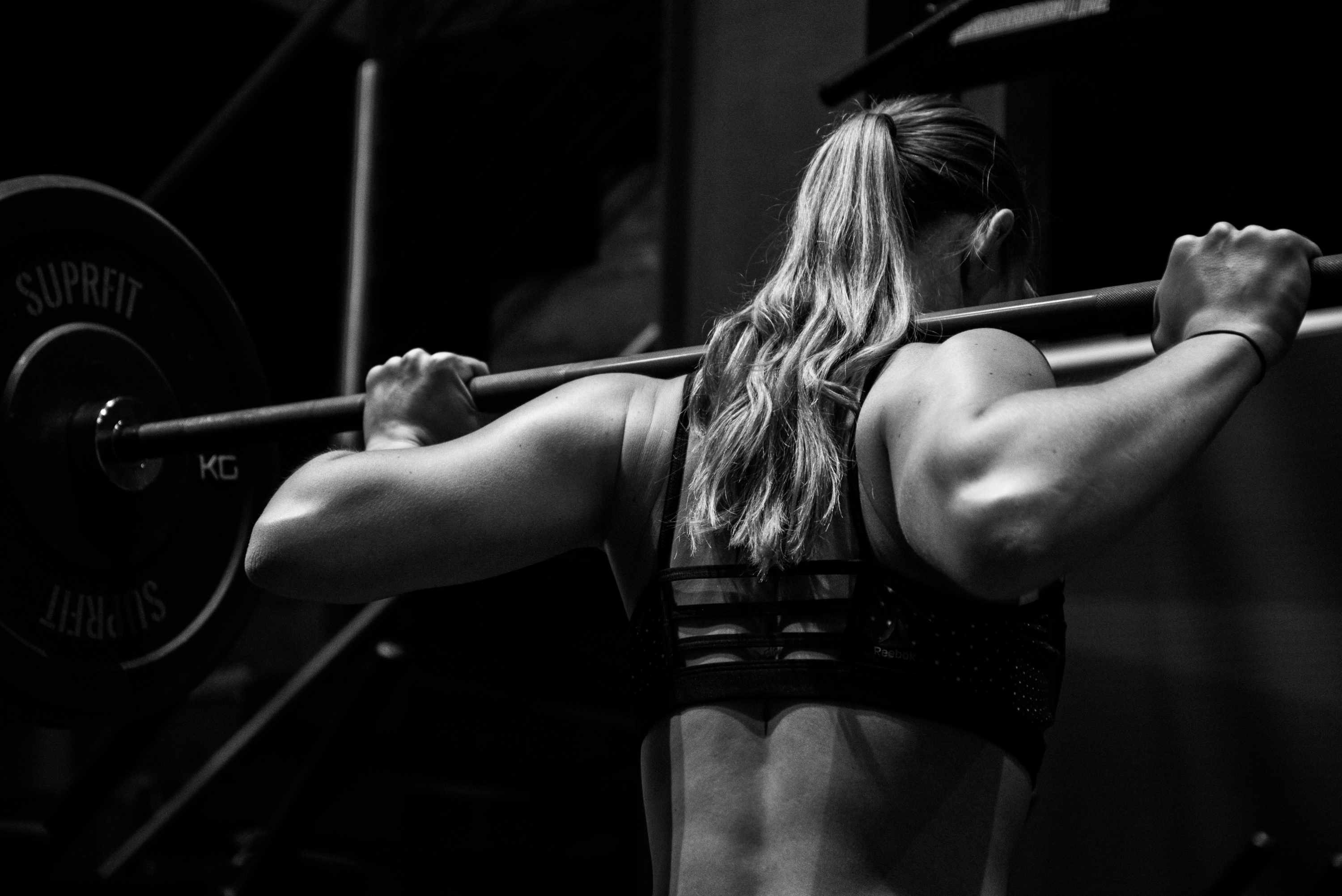 Woman about to perform a barbell squat